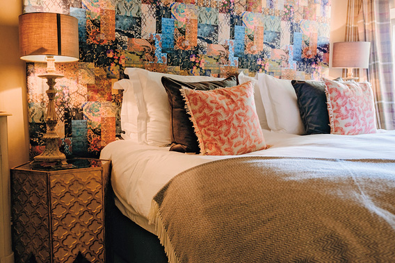 The two-bedroom Cadaman Cottage at The Gin Trap Inn has one bold pink, Moroccan-style bedroom and another chic navy-blue one