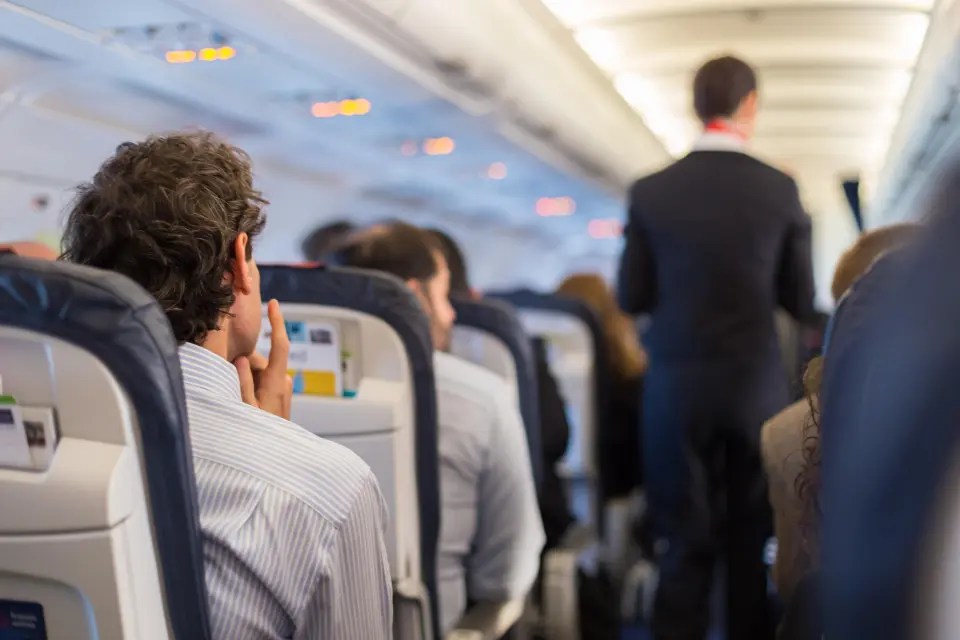 An aisle seat that is five rows away from the toilets is the best seat for a long-haul flight