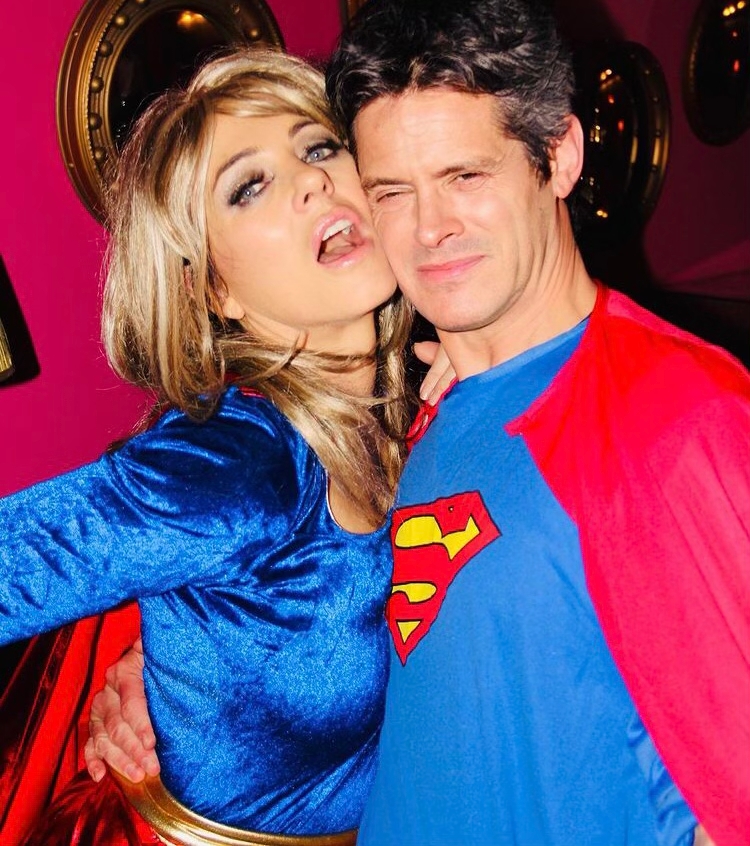 Liz Hurley poses on New Year’s Eve in a sexy superwoman costume