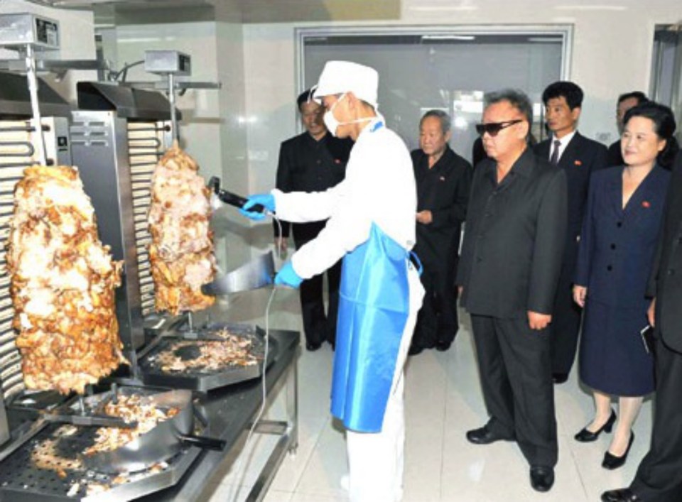 The late Kim Jong-il, pictured wearing sunglasses as he tours a kitchen, has bizarrely been credited with inventing the burrito