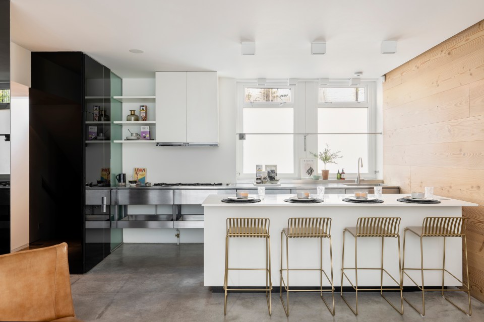 The kitchen boasts a modern and sleek breakfast island