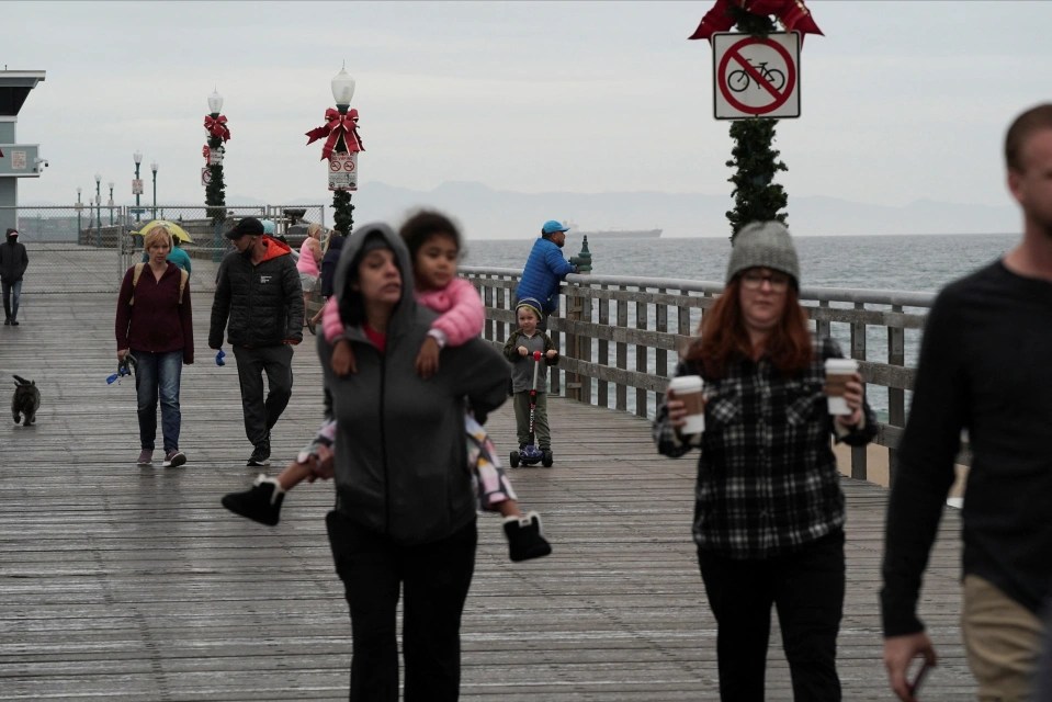 People flock to view waves from Seal Beach pier in California