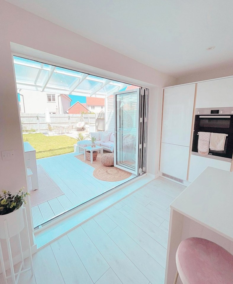 The kitchen has stunning french doors that lead out to the pink themed garden