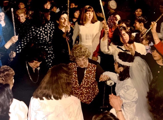 Jill at her wedding with holding Ilse's hand with Carla next to her