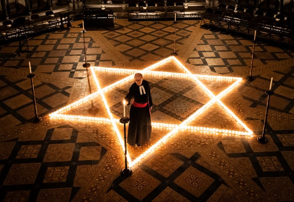 The Reverend Canon Michael Smith, Acting Dean of York, helps light six hundred candles in the shape of the Star of David, for Holocaust Memorial Day 2022