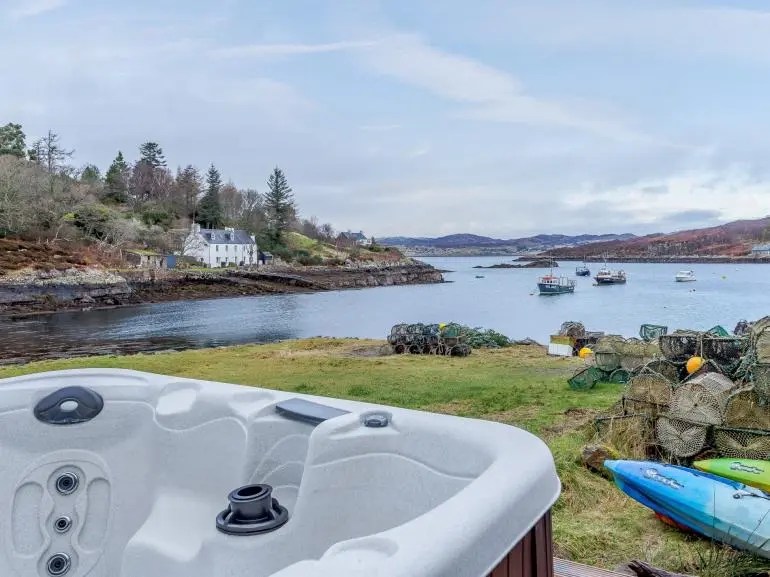 Relax in a hot tub overlooking the private island and the Highland surroundings