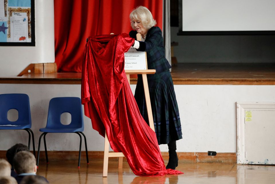 The Duchess of Cornwall unveiling a plaque during a school visit in Southdown, Bath today.