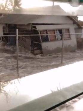 The waves swirled around homes and buildings in the Pacific nation