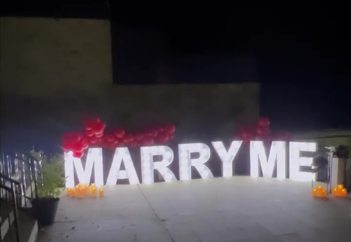 The Leeds man showed off a Marry Me sign in his back garden