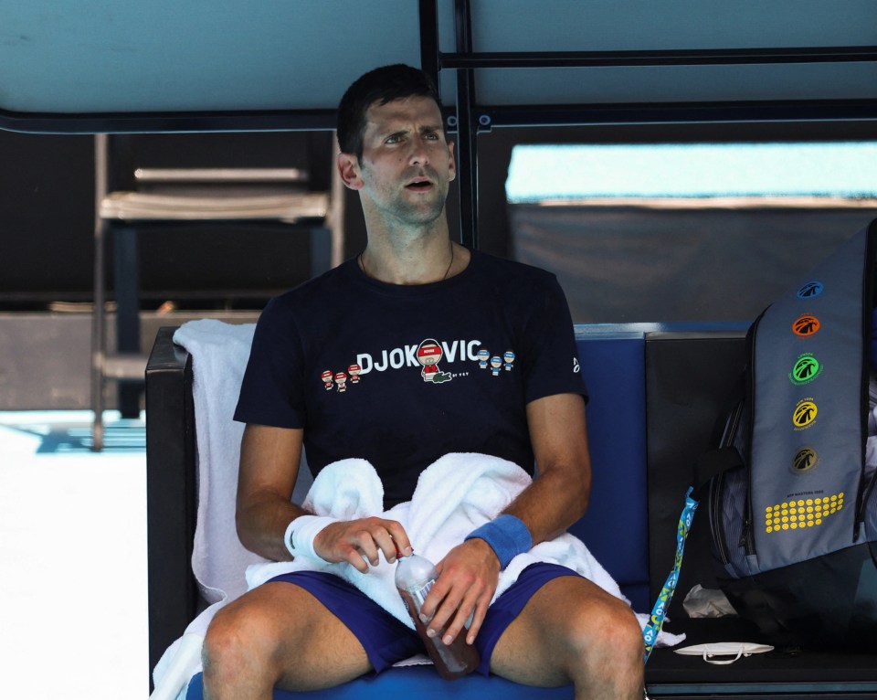 Novak Djokovic rests at Melbourne Park during training ahead of a decision on his visa