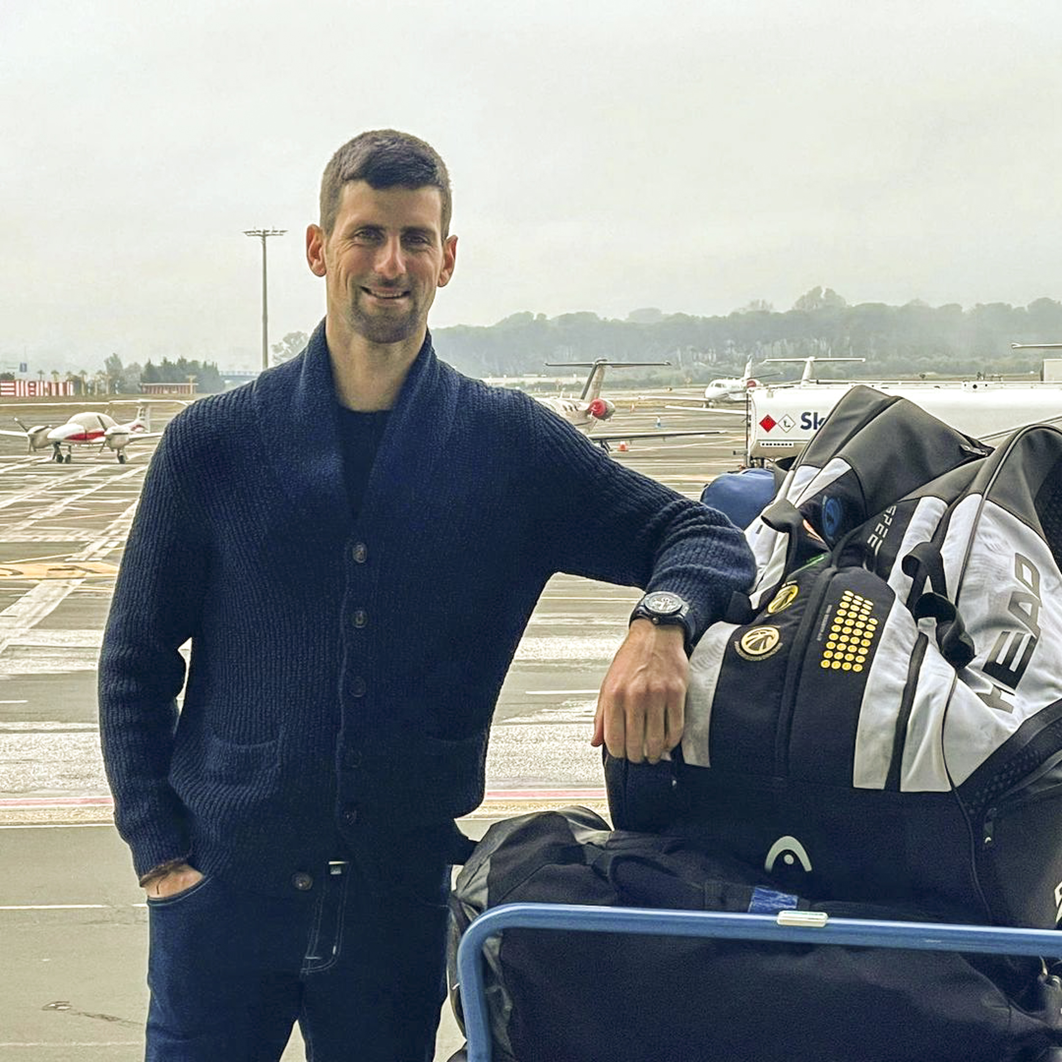 Novak Djokovic with his luggage on the way to the Australian Open this week