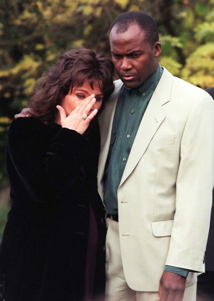 Mandy grieving at the babies' funeral with their father Paul Hudson