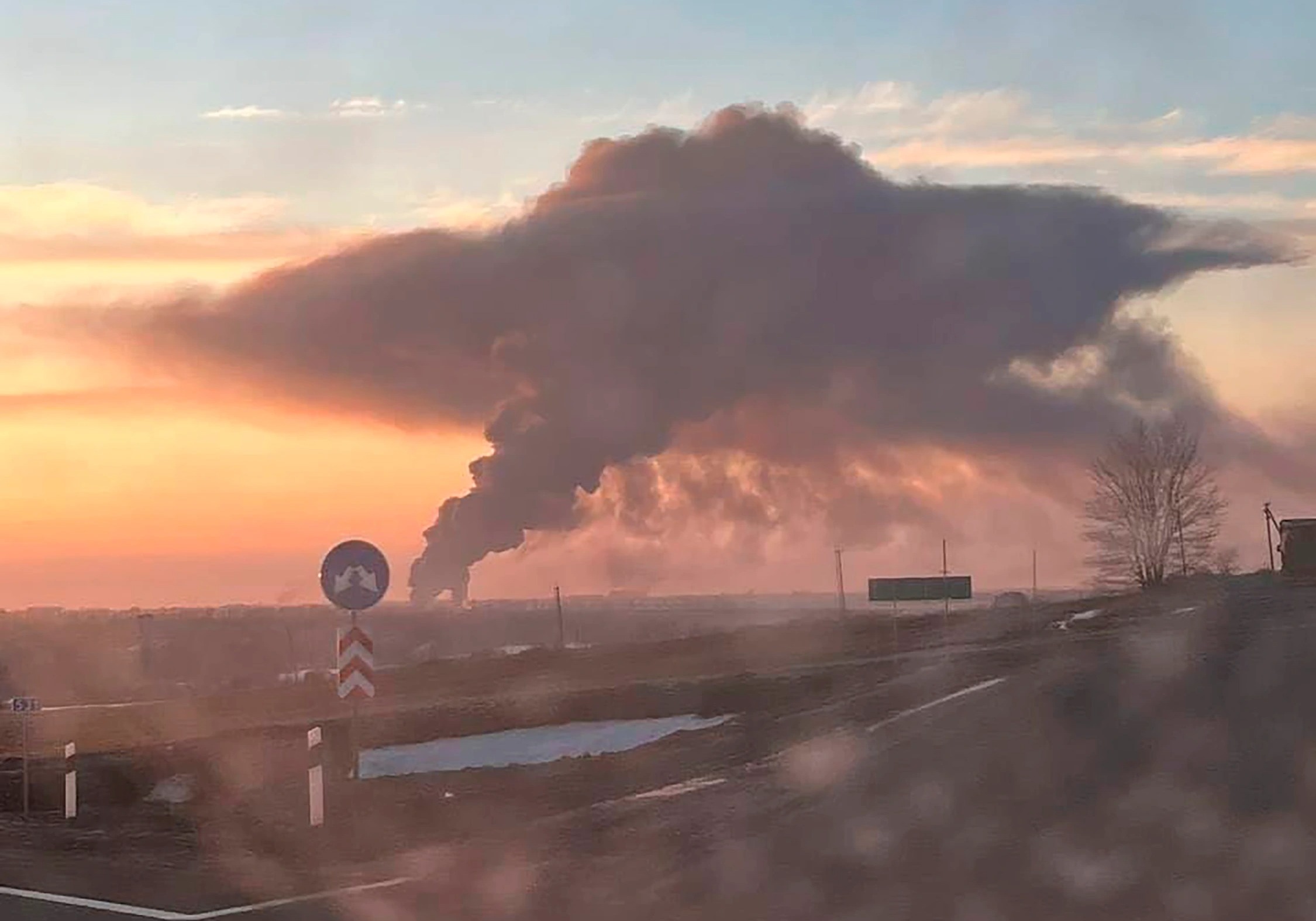 Dawn broke on a besieged Ukraine - picture shows Chuhuiv military airfield in Kharkiv outskirts burning after a Russian strike  Credit: East2West