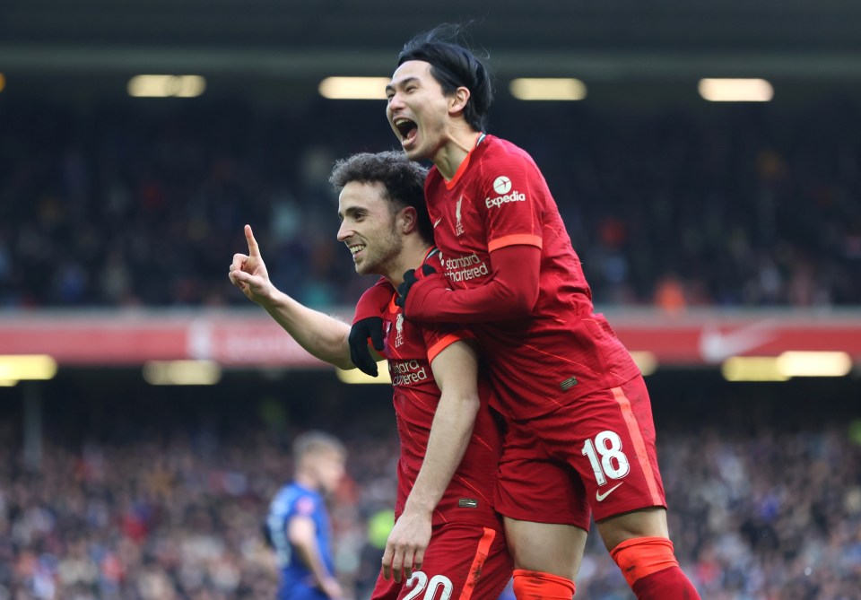 Diogo Jota celebrates his opener with Takumi Minamino