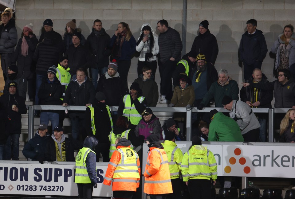 Medics from both teams raced over to help the supporter within the home section