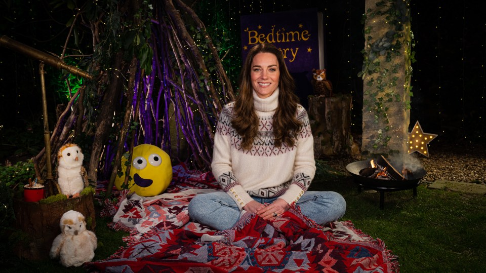 Kate wears a comfy roll-neck sweater, jeans and sits cross-legged during the programme