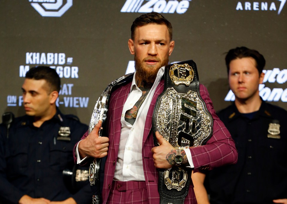 Conor McGregor holding two UFC titles