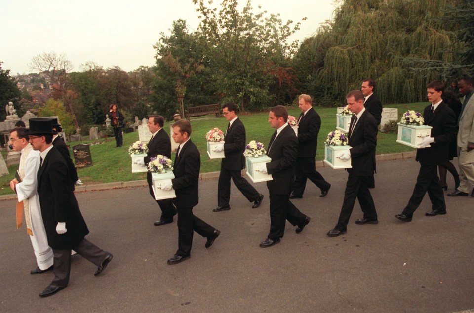 The coffins of the eight babies, who died at 24 weeks, are carried in procession during their funeral in West Norwood Cemetery in 1996