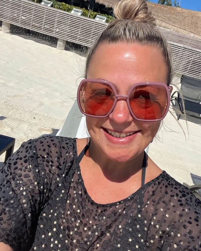 She shared a beaming selfie of herself relaxing on the beach