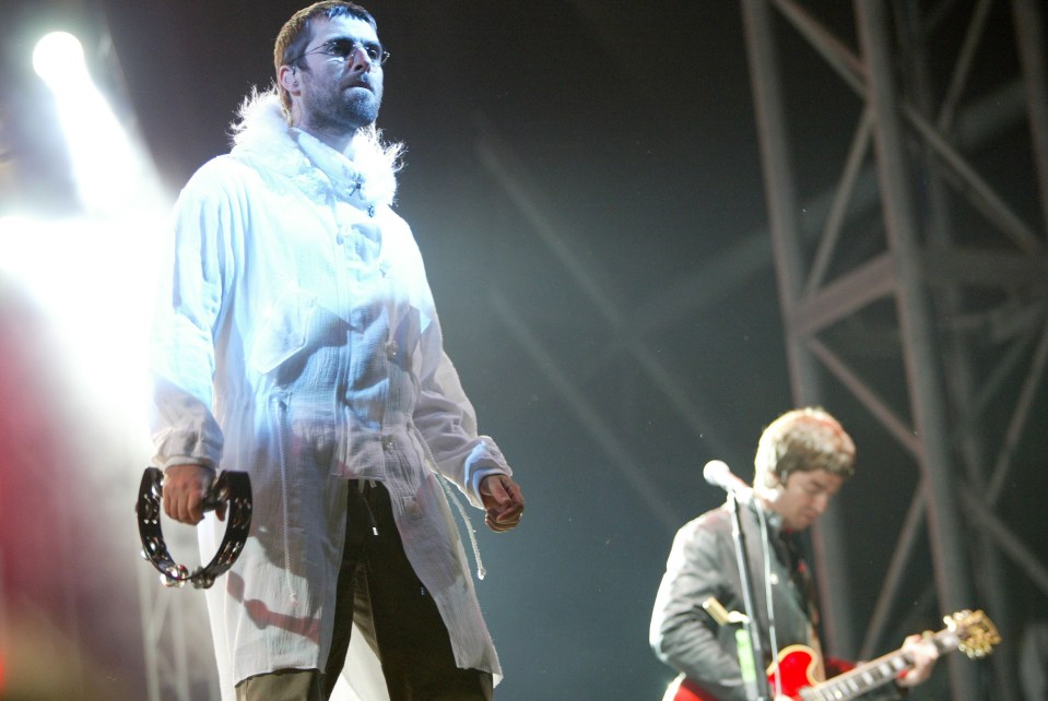 Noel, right, on stage with his brother Liam when Oasis played Worthy Farm for a second time in 2004