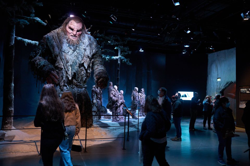 Visitors enter the tour through an icy tunnel