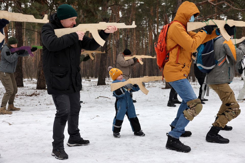 The boy, 4, poses with the rest of the volunteers