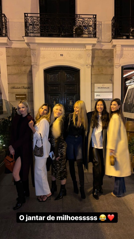 The group pose together outside the restaurant