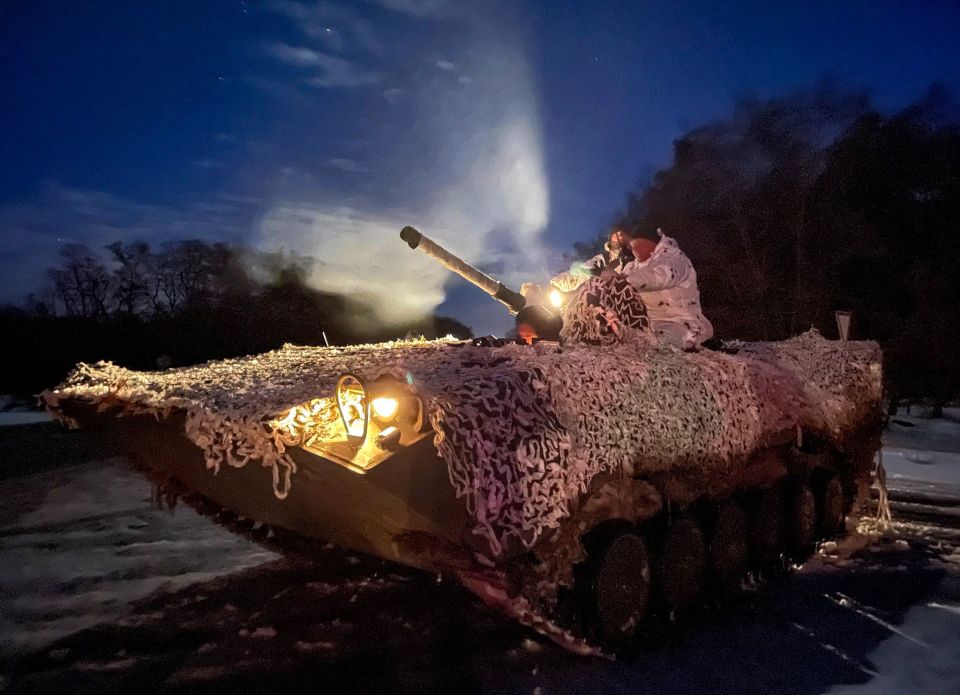 Ukrainian forces pictured on night time drills in preparation for a Russian invasion