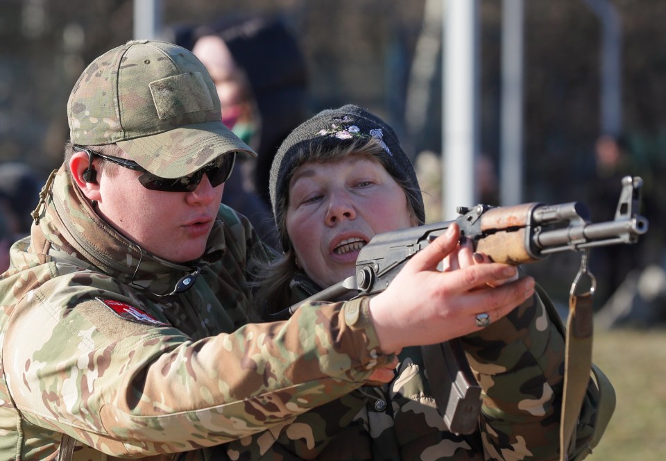 One woman was seen being shown how to aim the gun