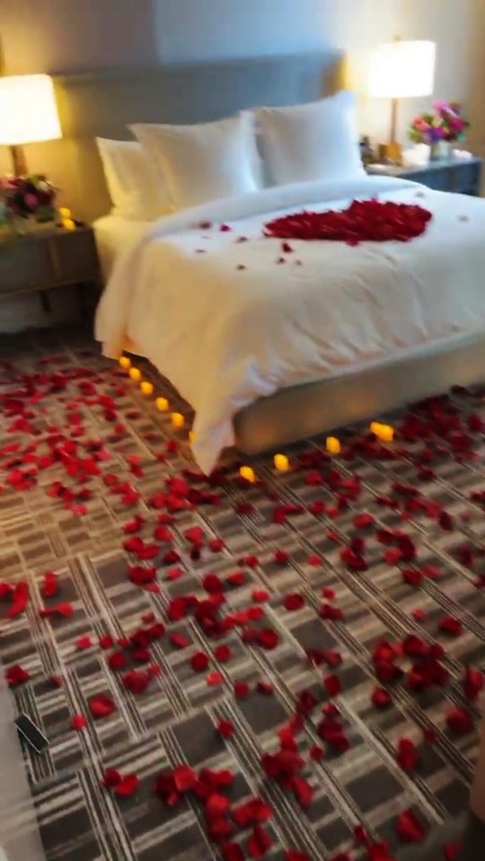 The bed was surrounded by candles and rose petals