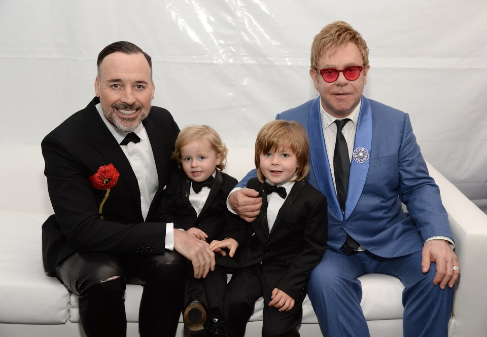 Elton pictured with husband David and their two sons