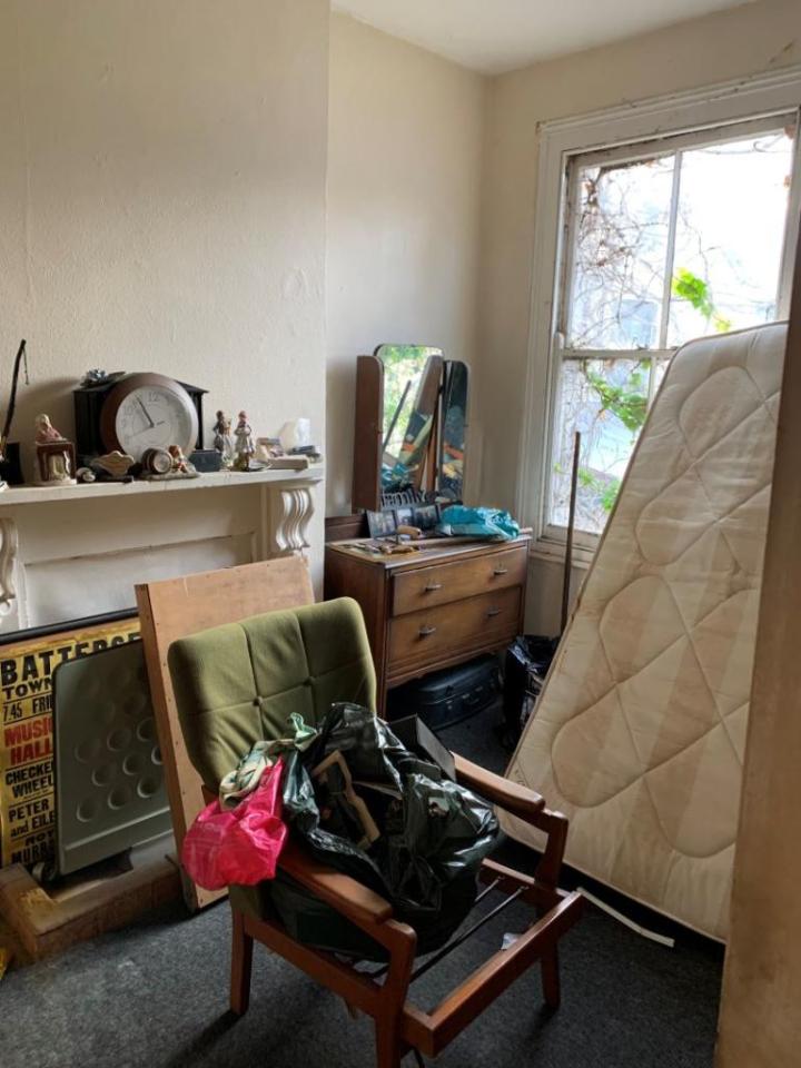 One of the rooms in the home is cluttered with old furniture