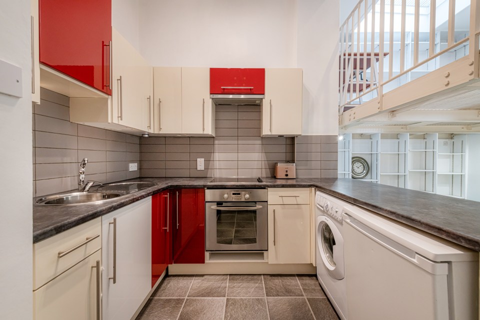 The entertainment space leads to a fully-fitted kitchen