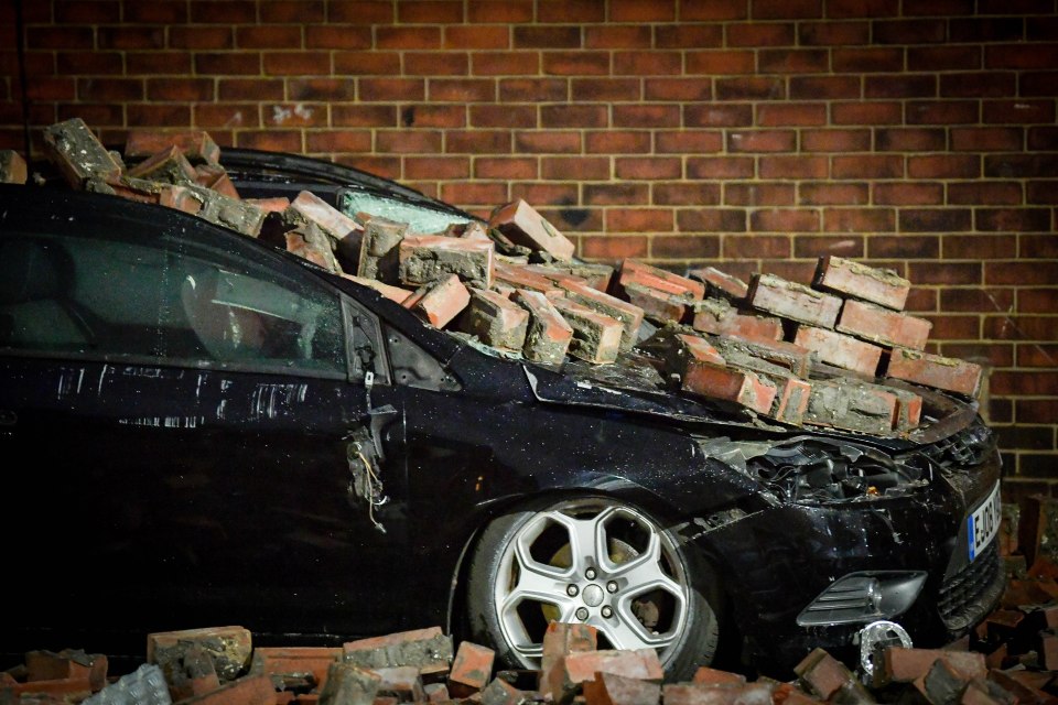 A car was smashed to bits by bricks blown off a house in Salford, Greater Manchester