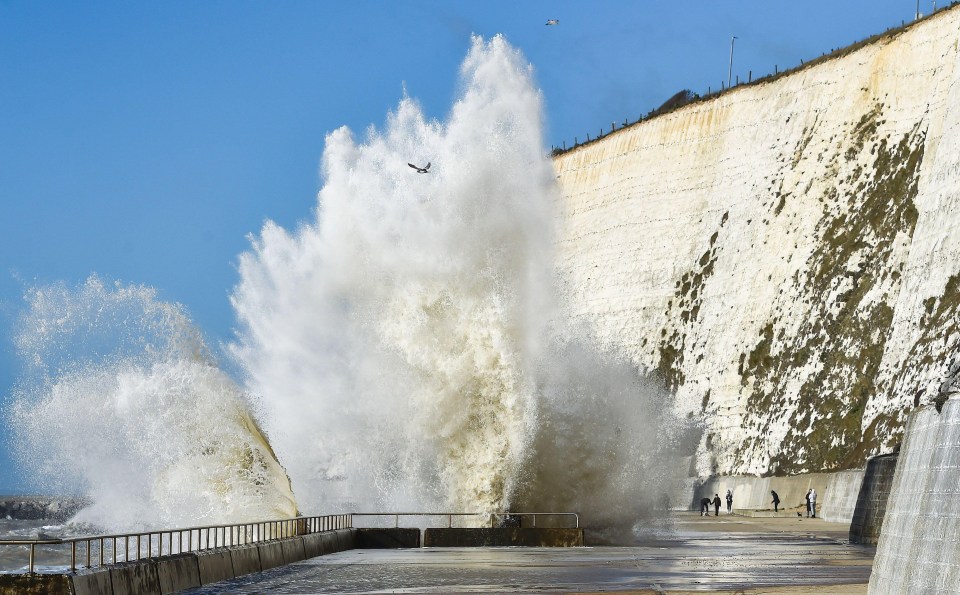 Huge waves crash over the undercliff walk at Saltdean near Brighton as winds pick up in February 2022