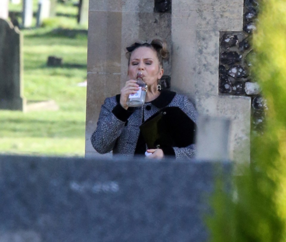 She drowns her sorrows at the graveside of her sister in law