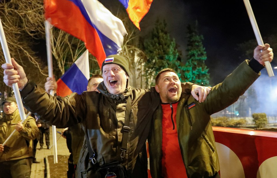 Pro-Russian activists celebrate in the streets after Putin signed the decree