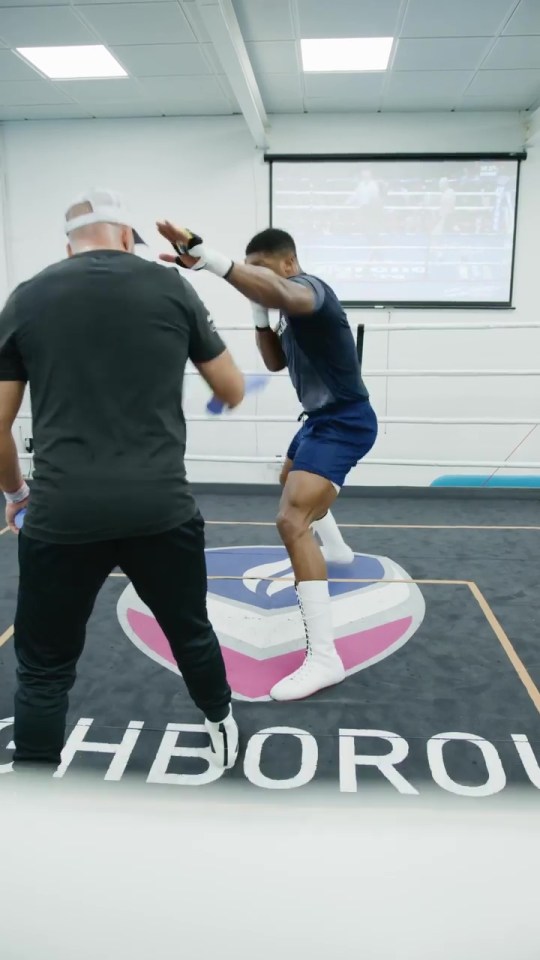 Anthony Joshua showed off his punching power... with a familiar face in the background