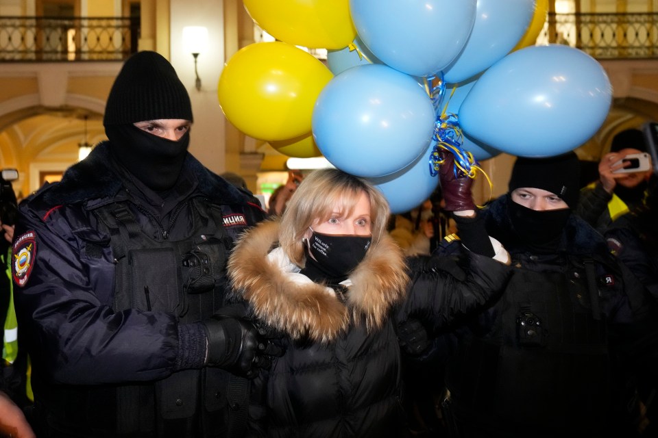 Police detain a woman during a protest against Russia's attack on Ukraine in St. Petersburg, Russia