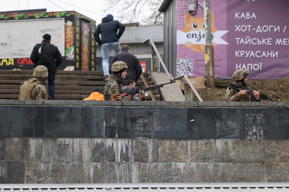 Soldiers dug in to positions on the main road out of Kyiv