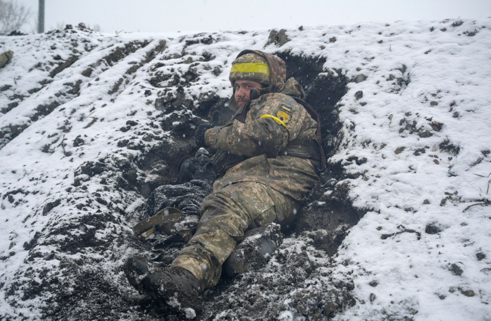 A soldier hunkering down in a trench as they battle with Putin's forces