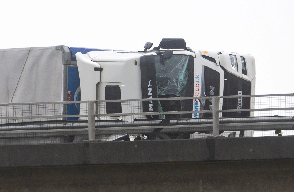 A lorry seen on its side on the M4 during Storm Eunice