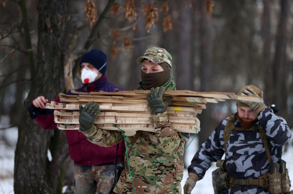 Soldiers help with the exercises using wooden guns