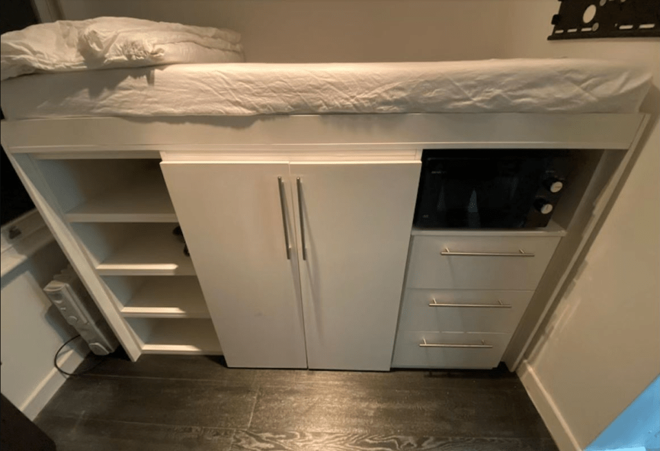 The bed is located above the makeshift kitchen