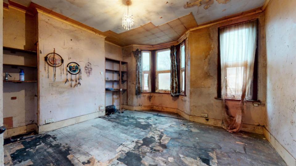 Torn curtains and rotten floorboards await prospective buyers