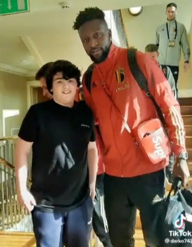 The youngster beamed as he posed with Liverpool and Belgium striker Origi as Henry trudged down the stairs