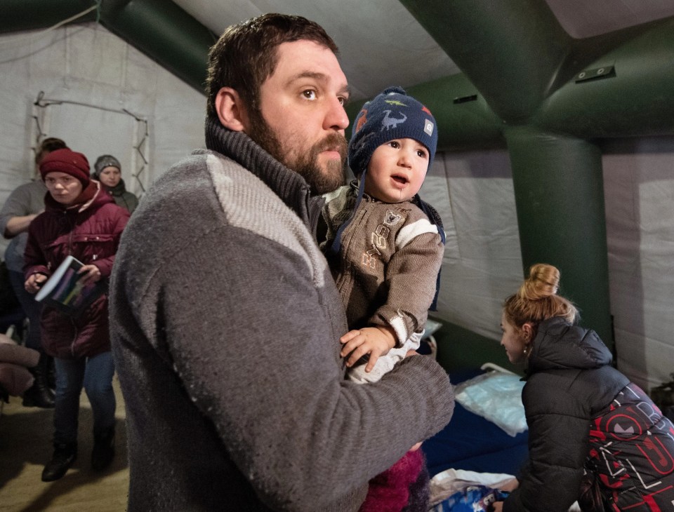 A dad and his child in sheltering from the the fighting in Mariupol