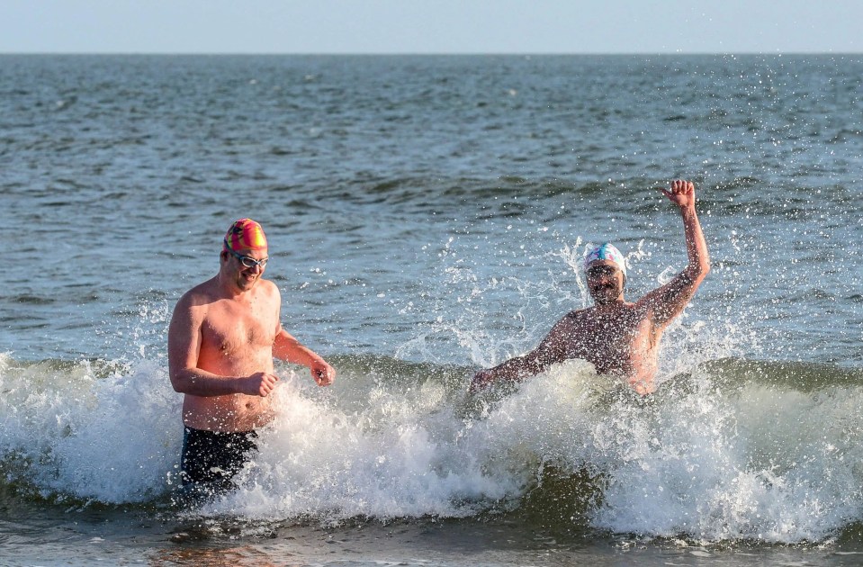 Early morning swimmers have fun in the sea at Tynemouth Longsands beach