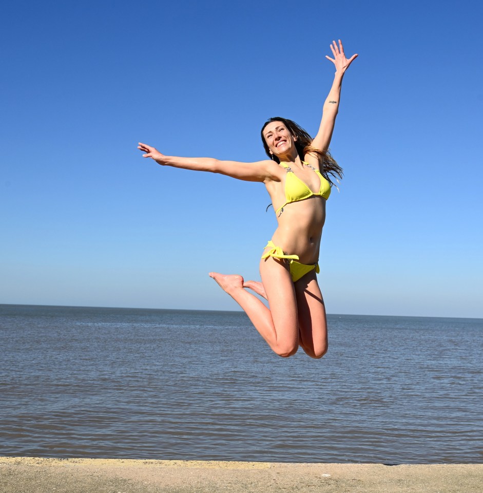 Becky Farran, 28, basks in the sunshine on Blackpool Beach