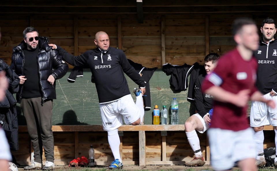 Ace Carlos warms up on the bench